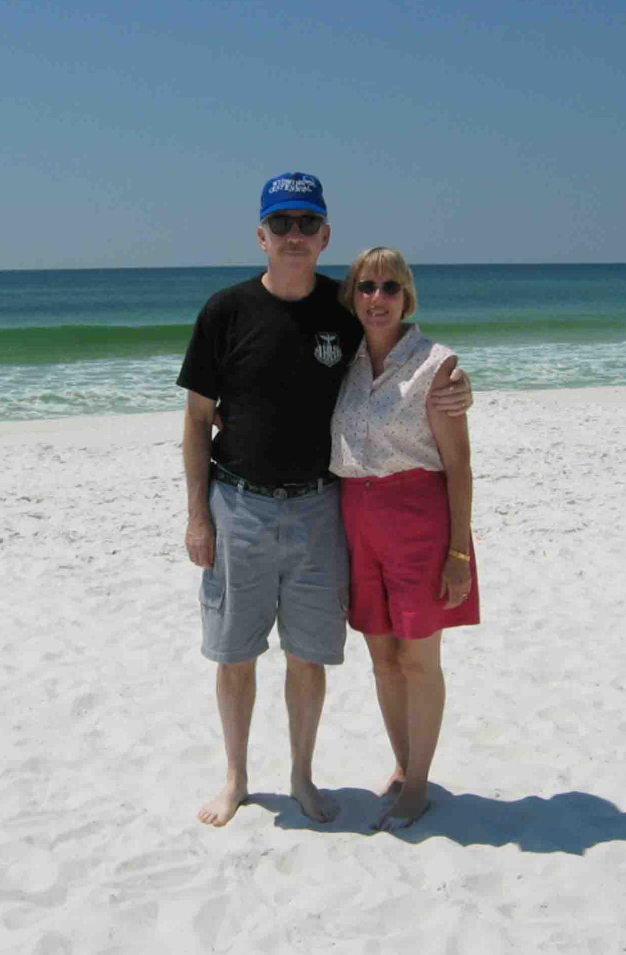 A man and woman standing on a beach