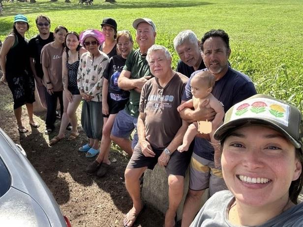 Group of people enjoy a fun day at the park while taking a moment for a picture together.