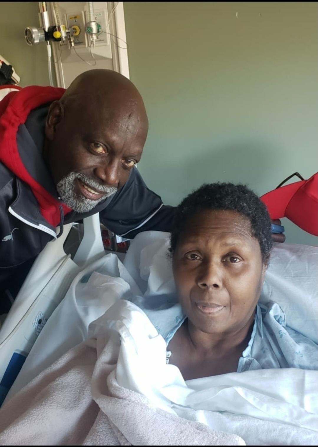 Two people are together in a hospital room while one person is recovering from illness.