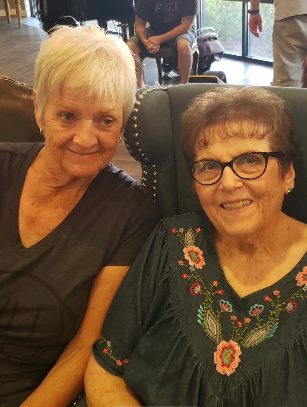 Two women sitting on a chair