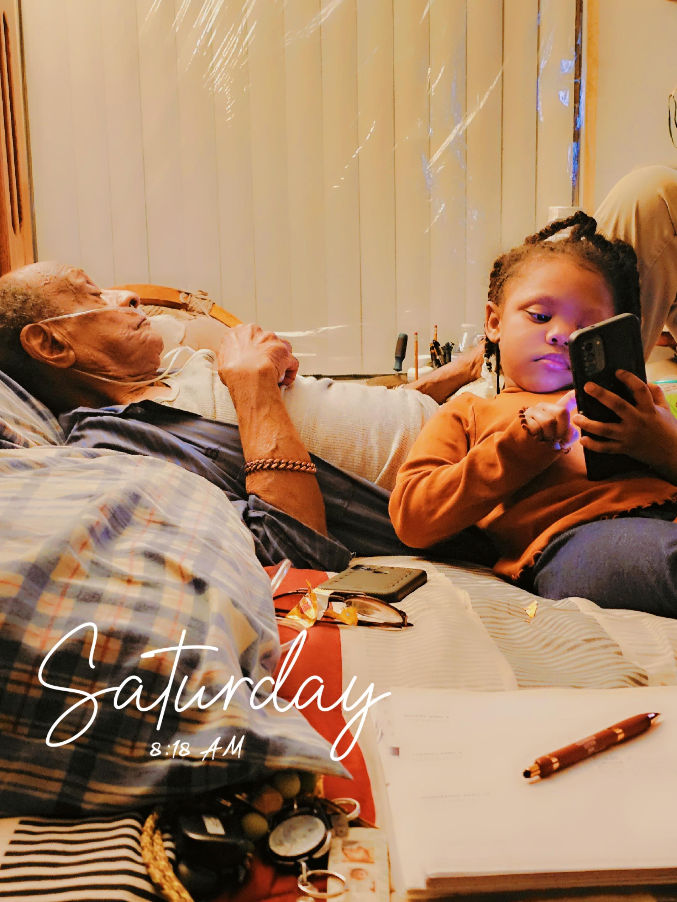 A man and a girl lying on a bed