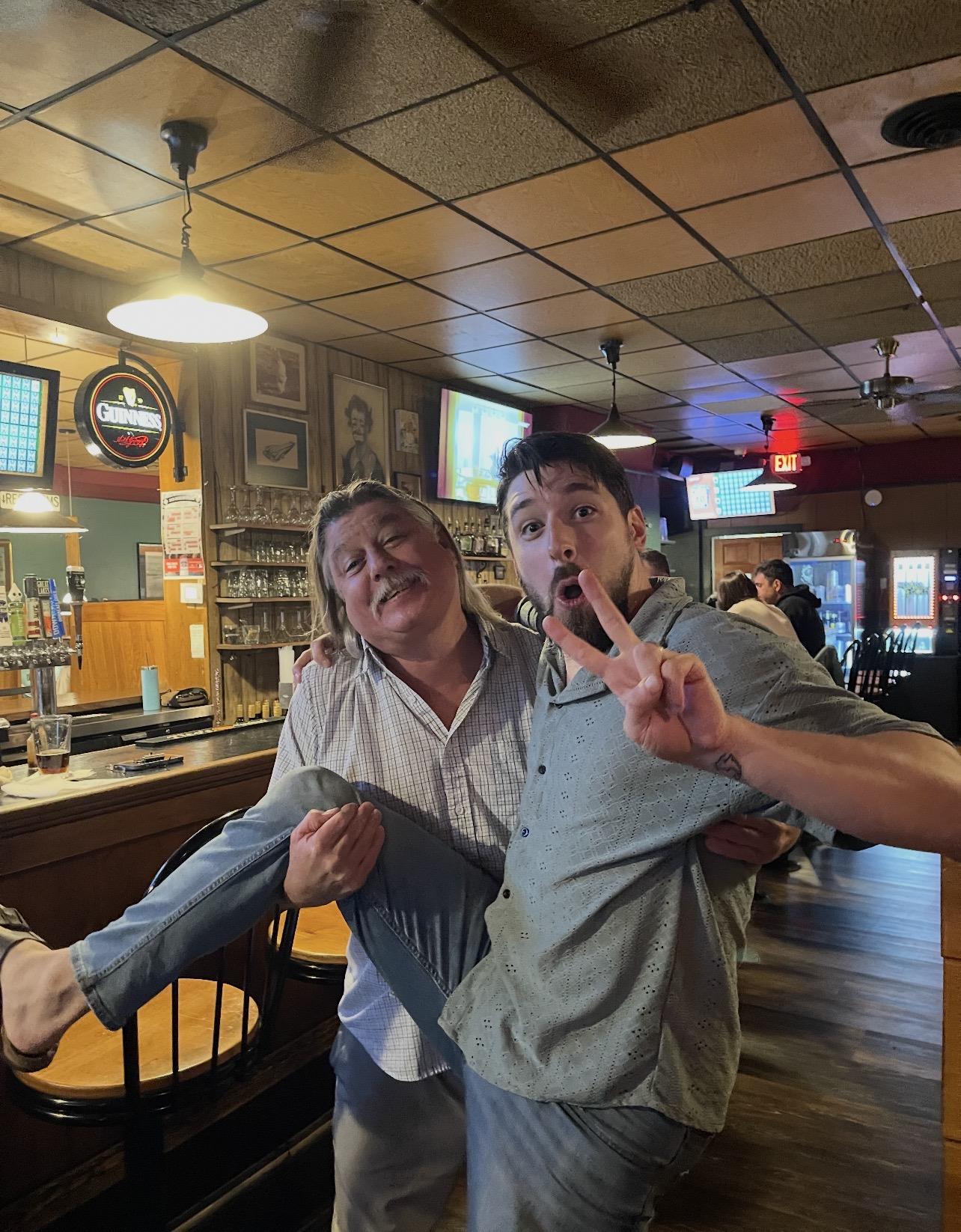 A man holding a woman in a bar