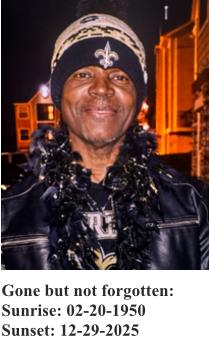 A man stands outside wearing a black coat and a hat.