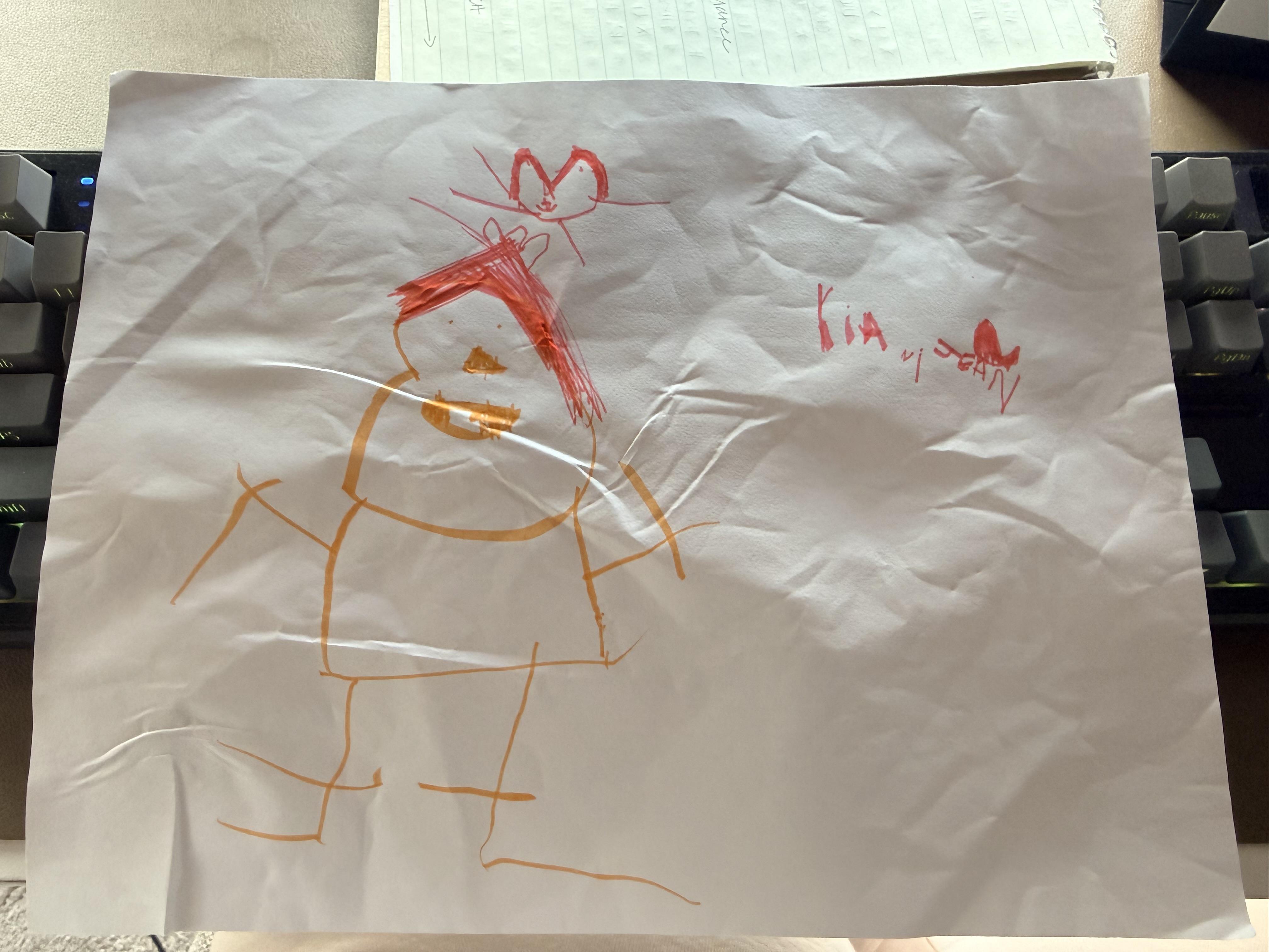 A child draws a figure with red hair and hearts, showing creativity during free art time.