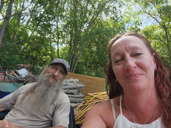 A woman taking a selfie with a man in a truck