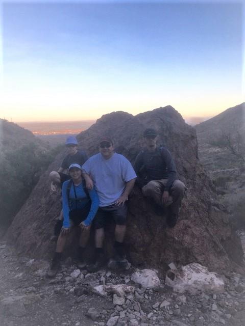 A group of people sitting on a rock