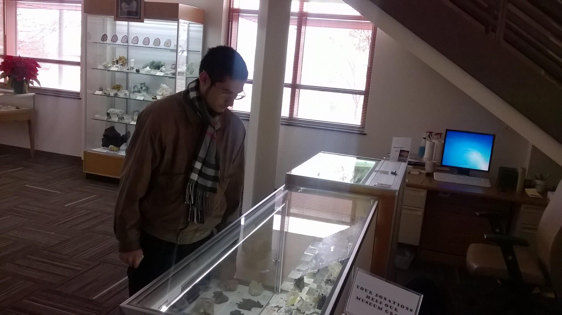 A man looking at a display case
