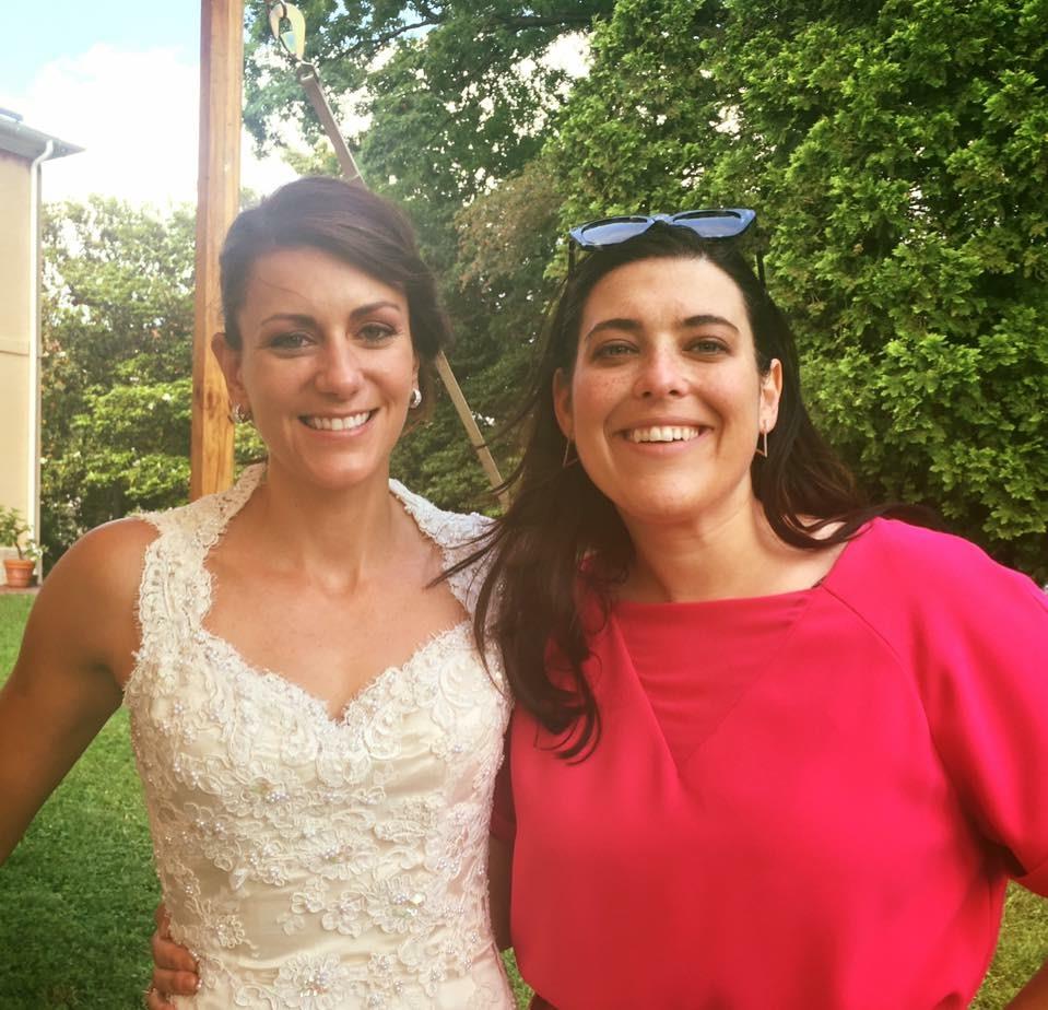 Two women standing together outside