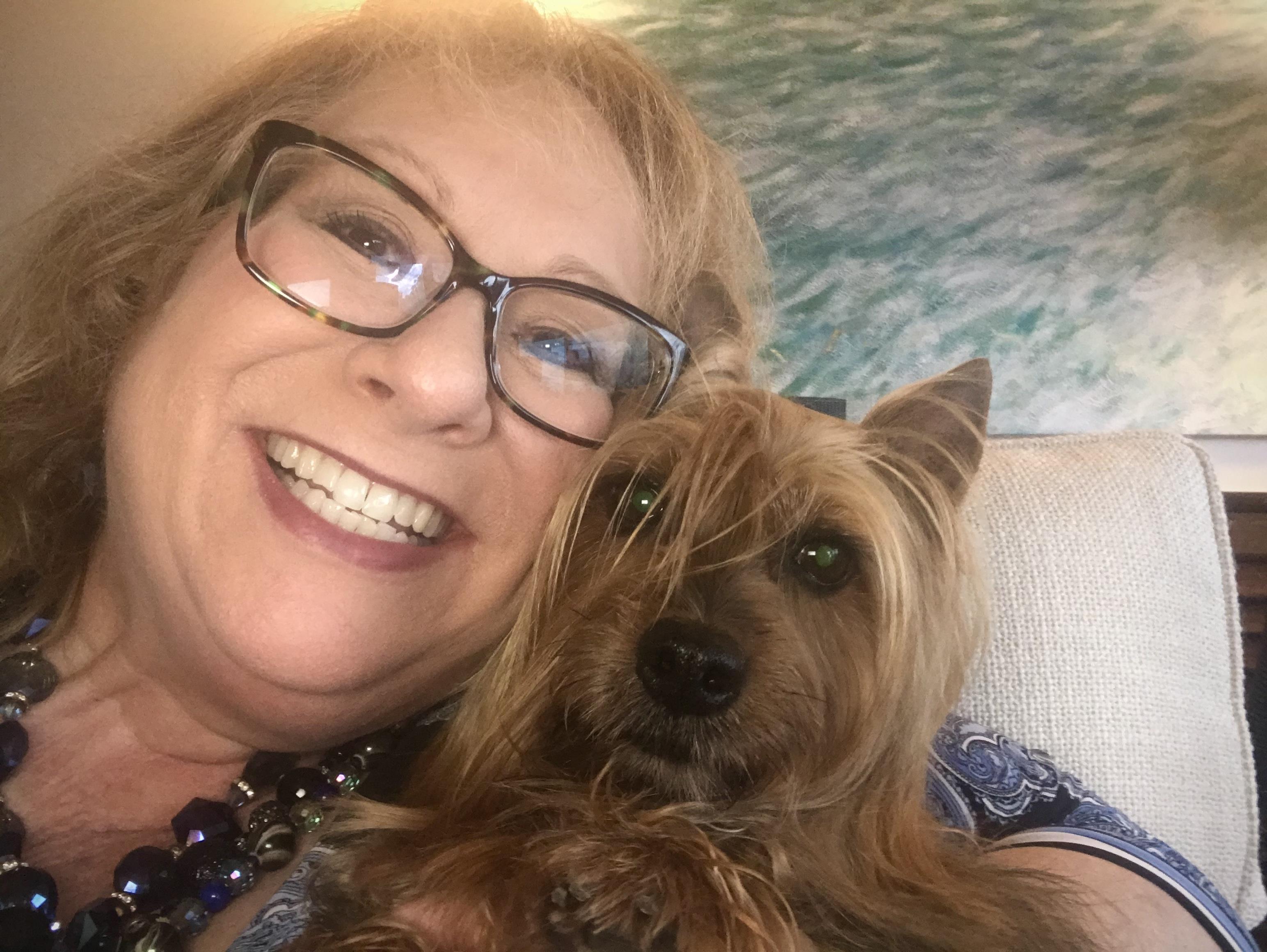 A woman taking a selfie with a dog