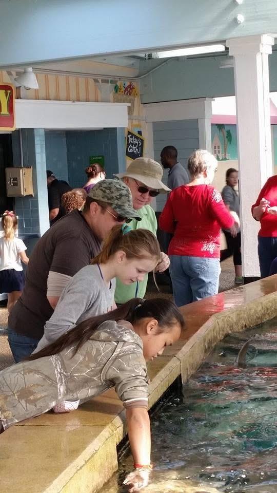 A group of people standing around a fountain