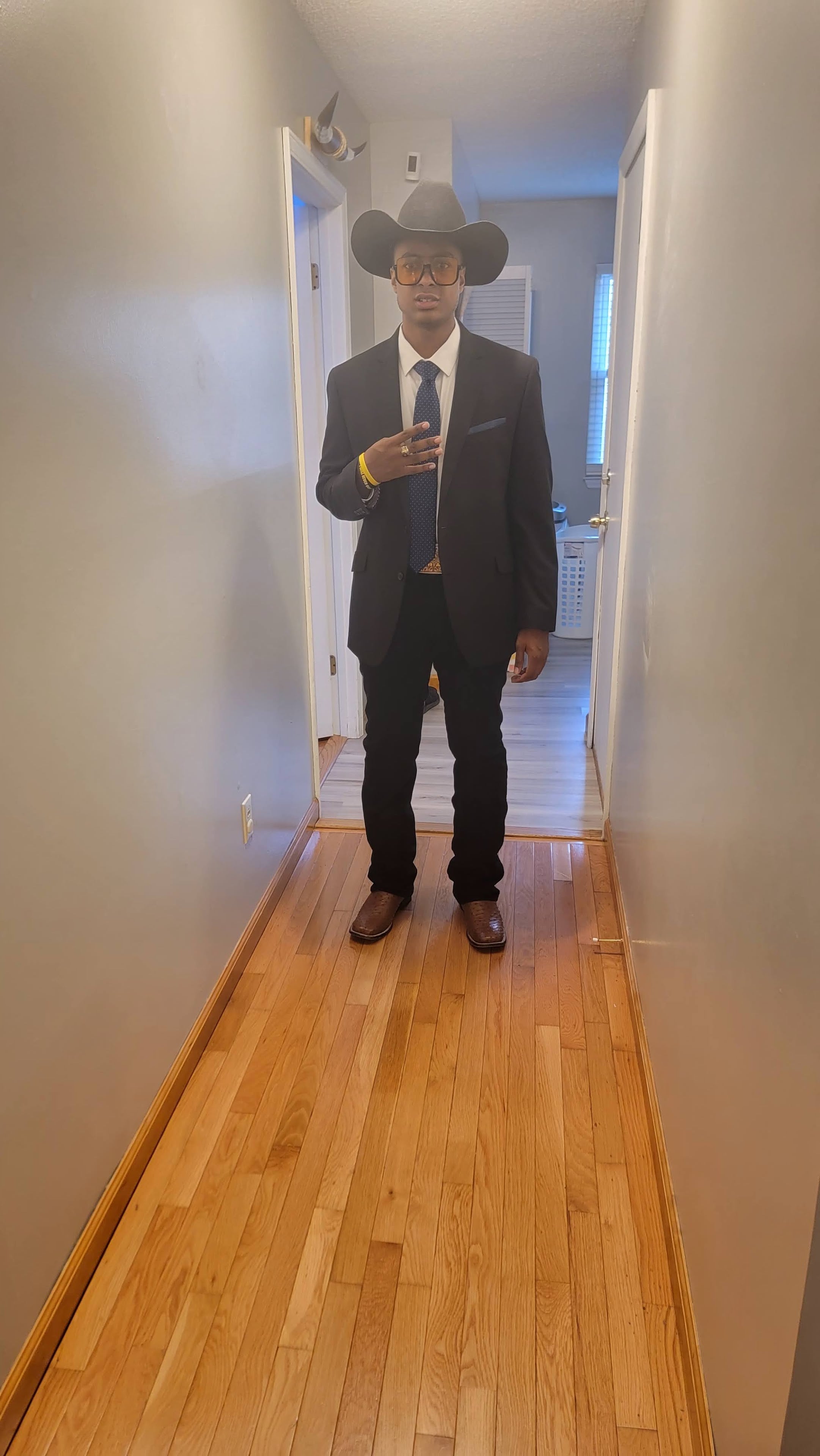 A man in a suit and tie standing in a hallway