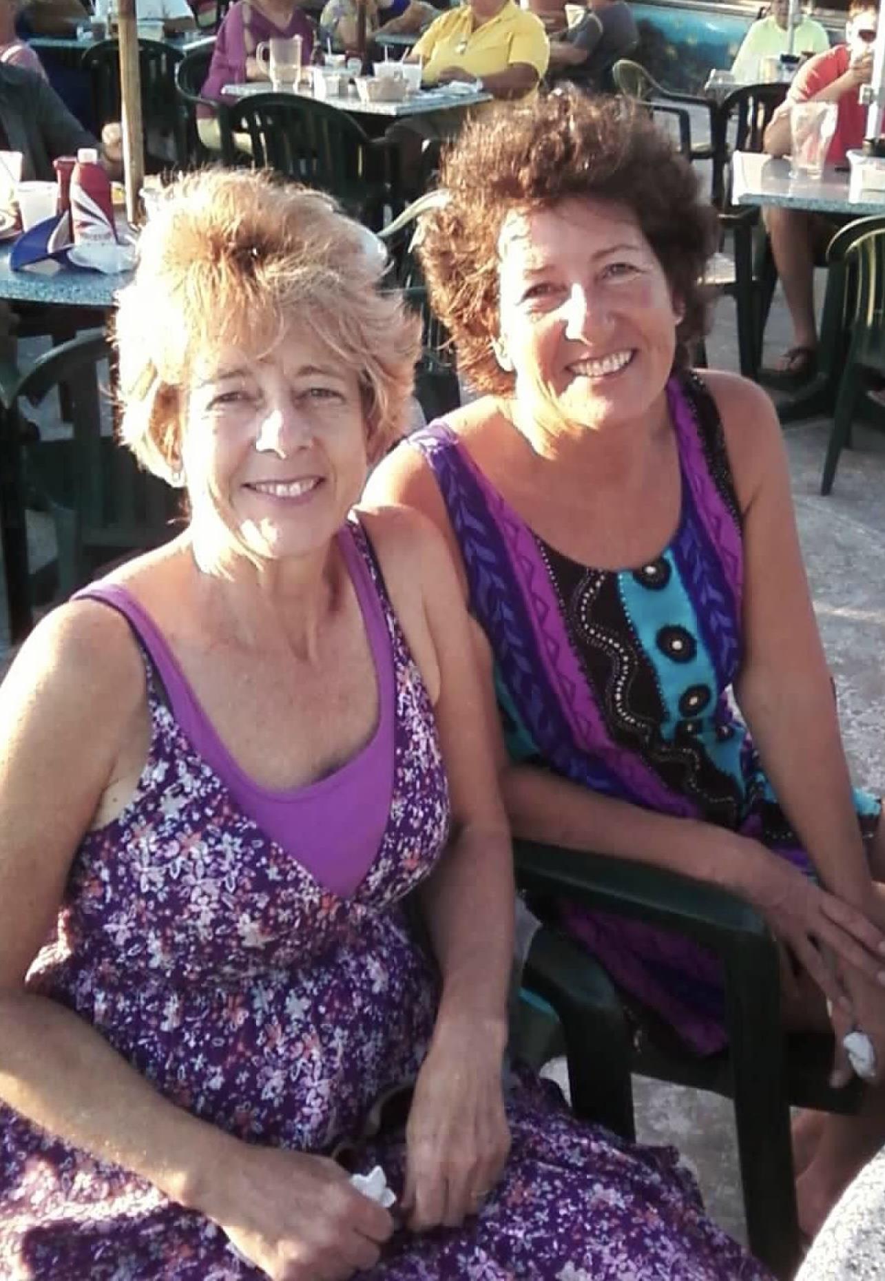 Two women sitting outside smiling