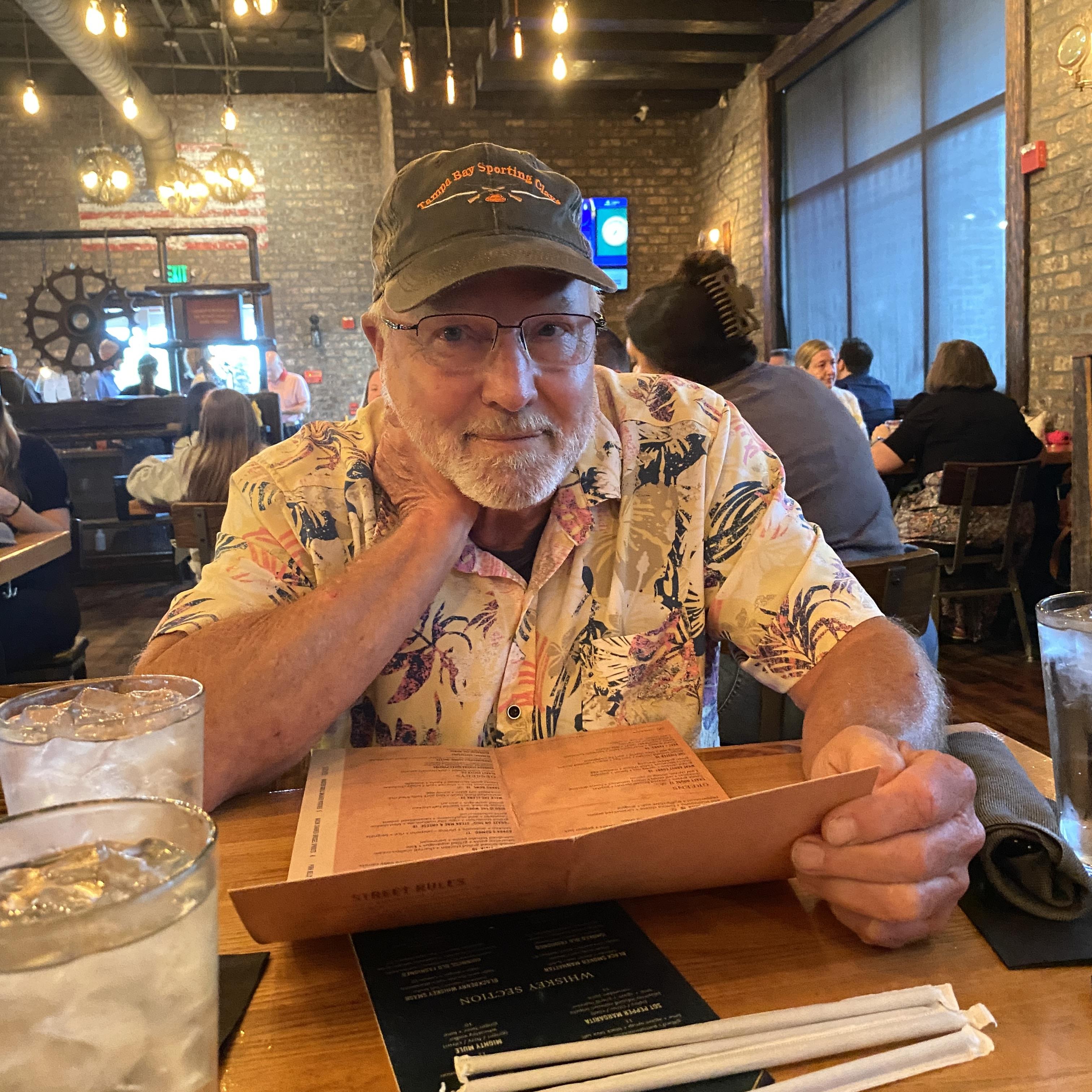 A man sitting at a table with a menu