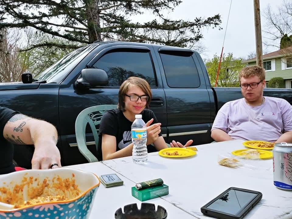 A group of people sitting at a table with food