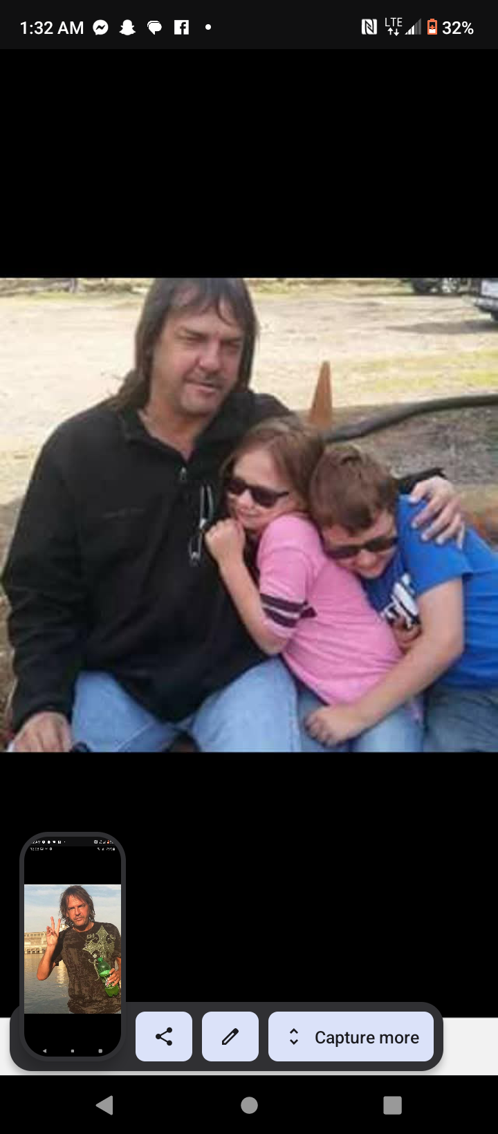 A man and two children posing for a picture