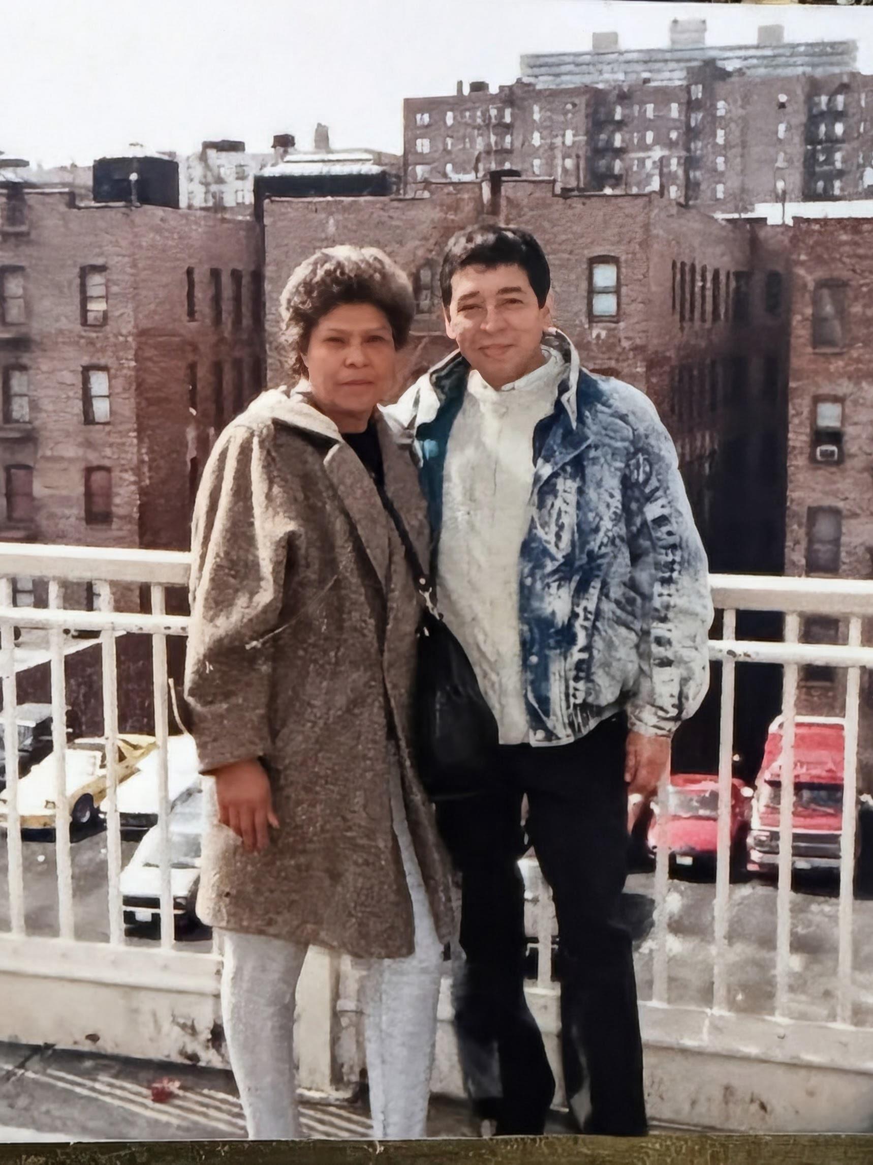 A man and woman standing on a balcony