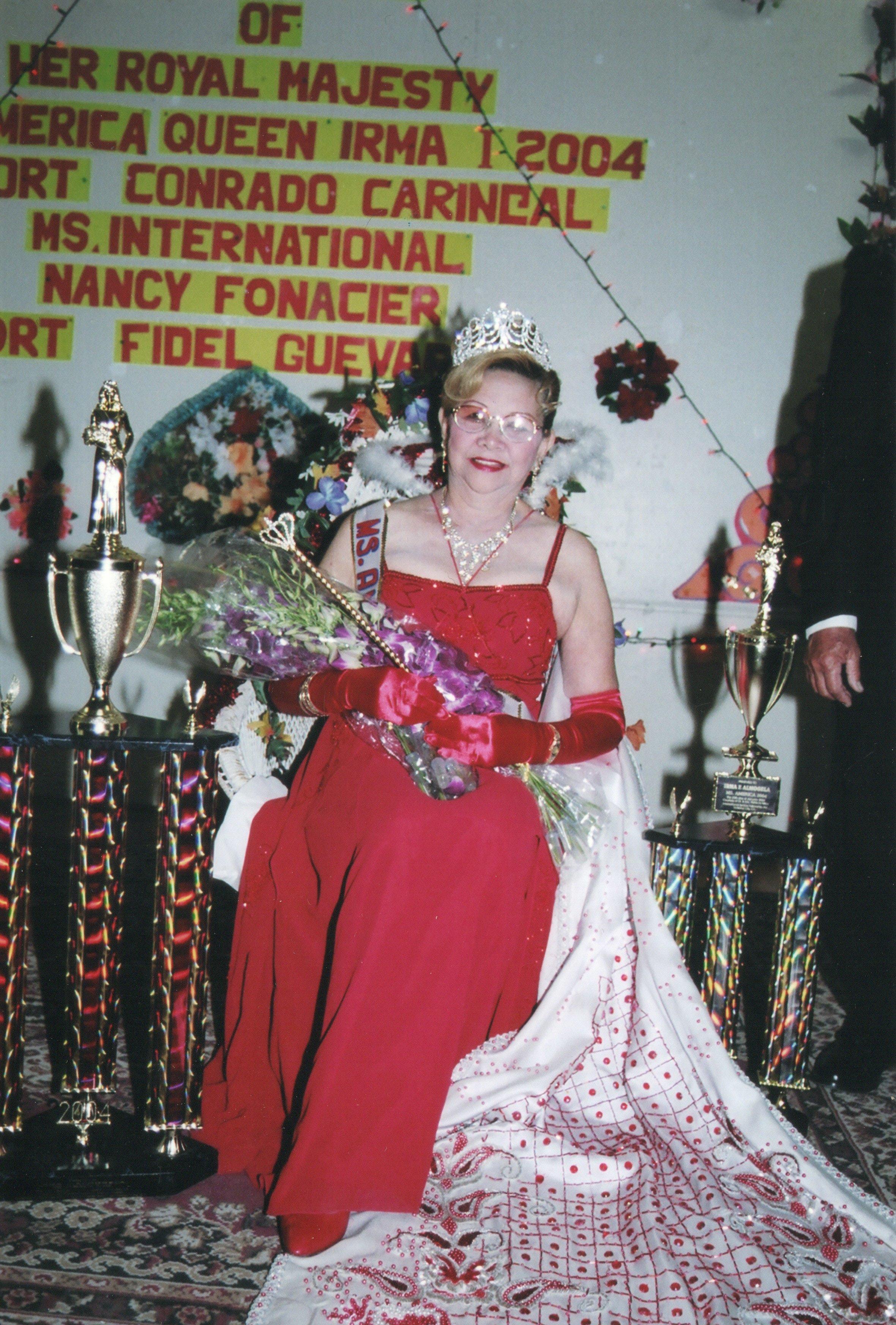 A woman in a red dress and tiara