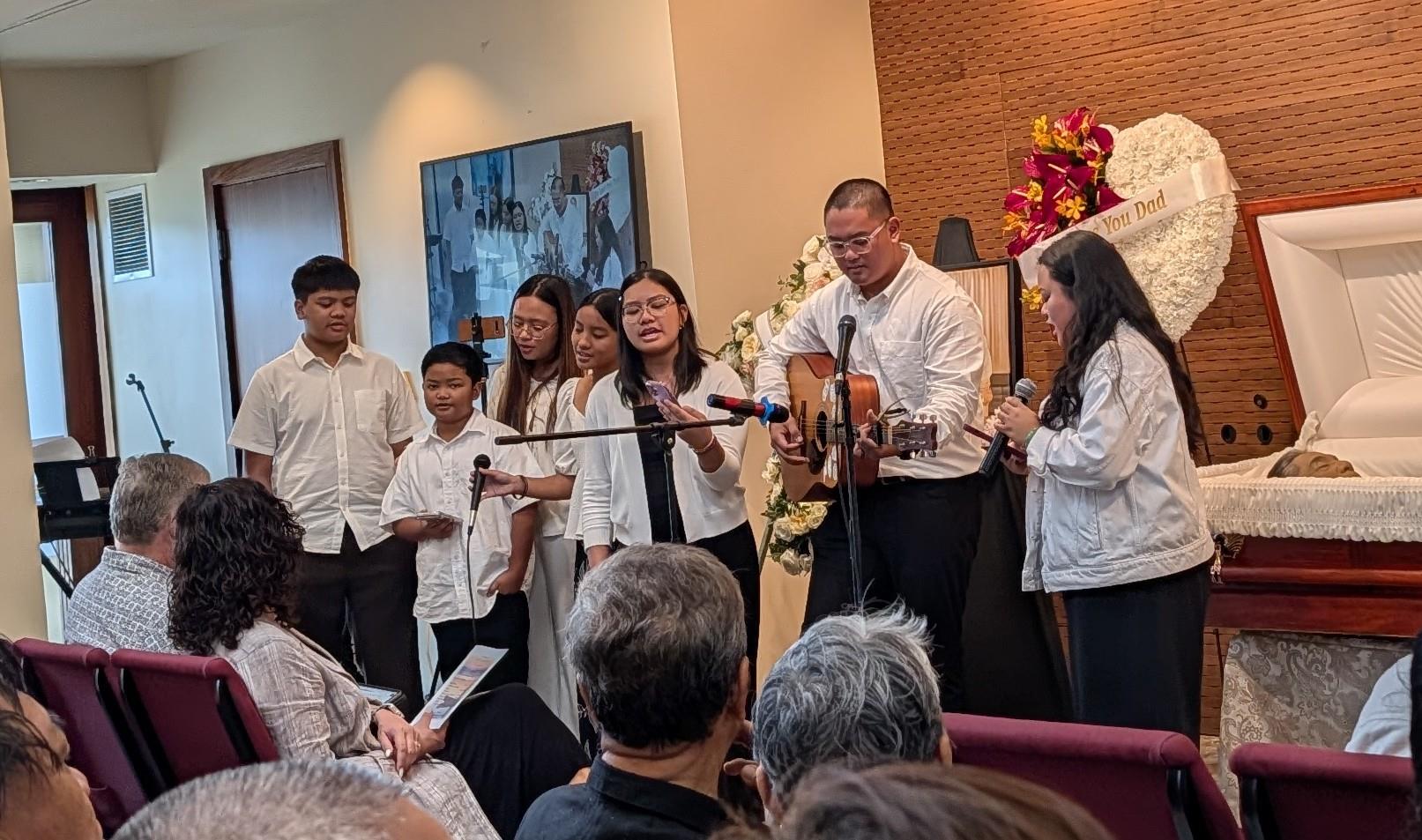 A group of people singing and playing instruments