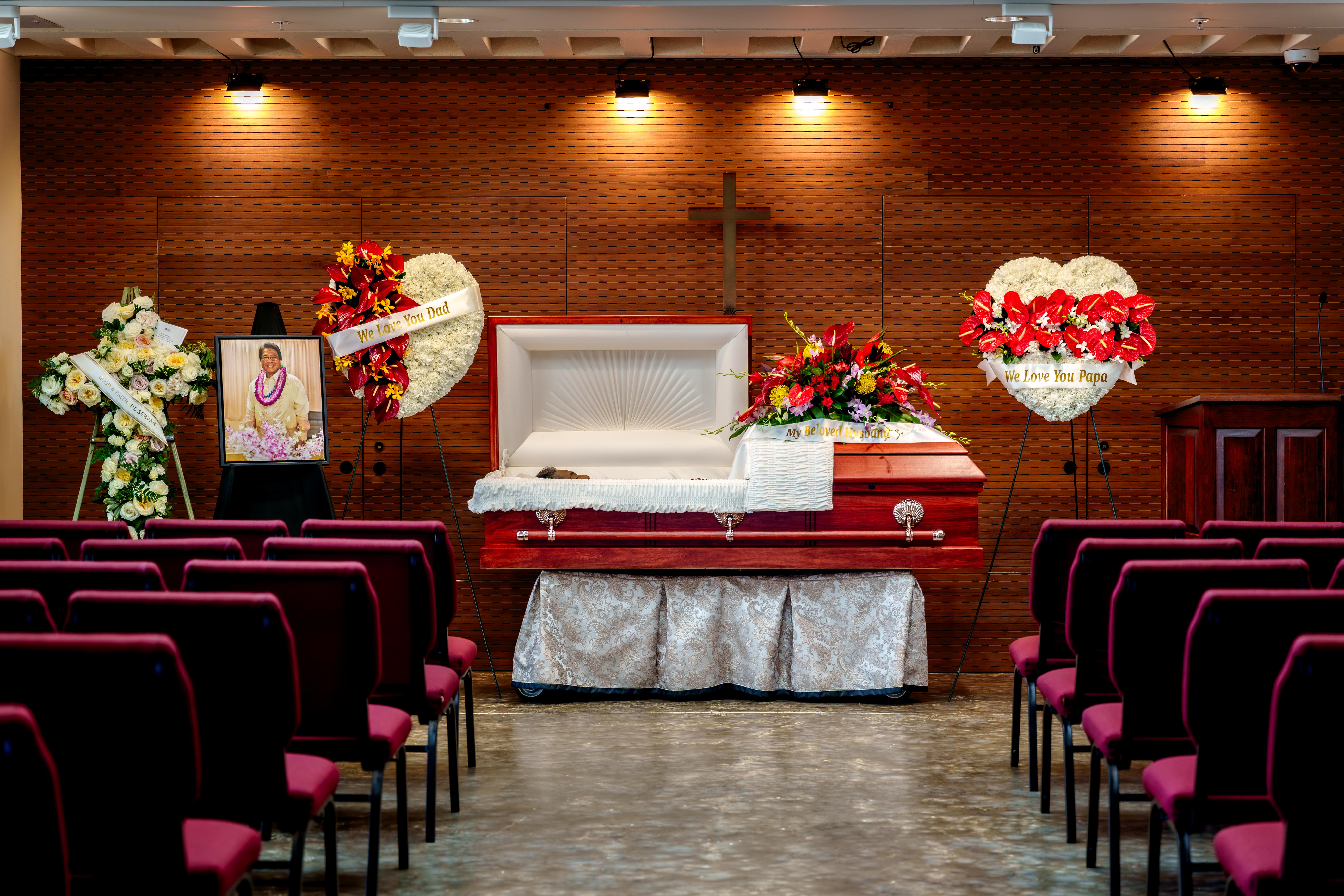 A casket in a room with chairs