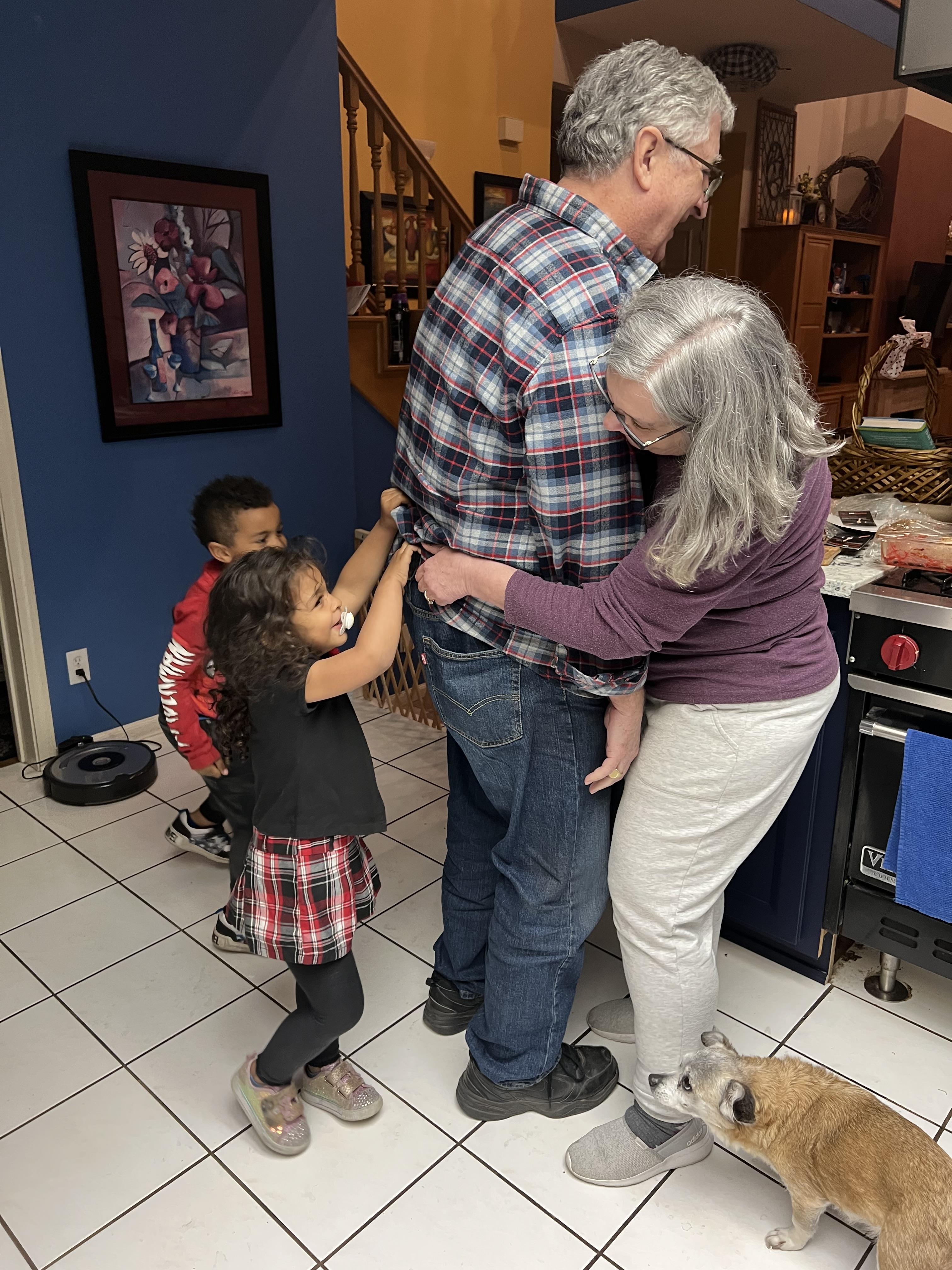 A group of people standing in a kitchen