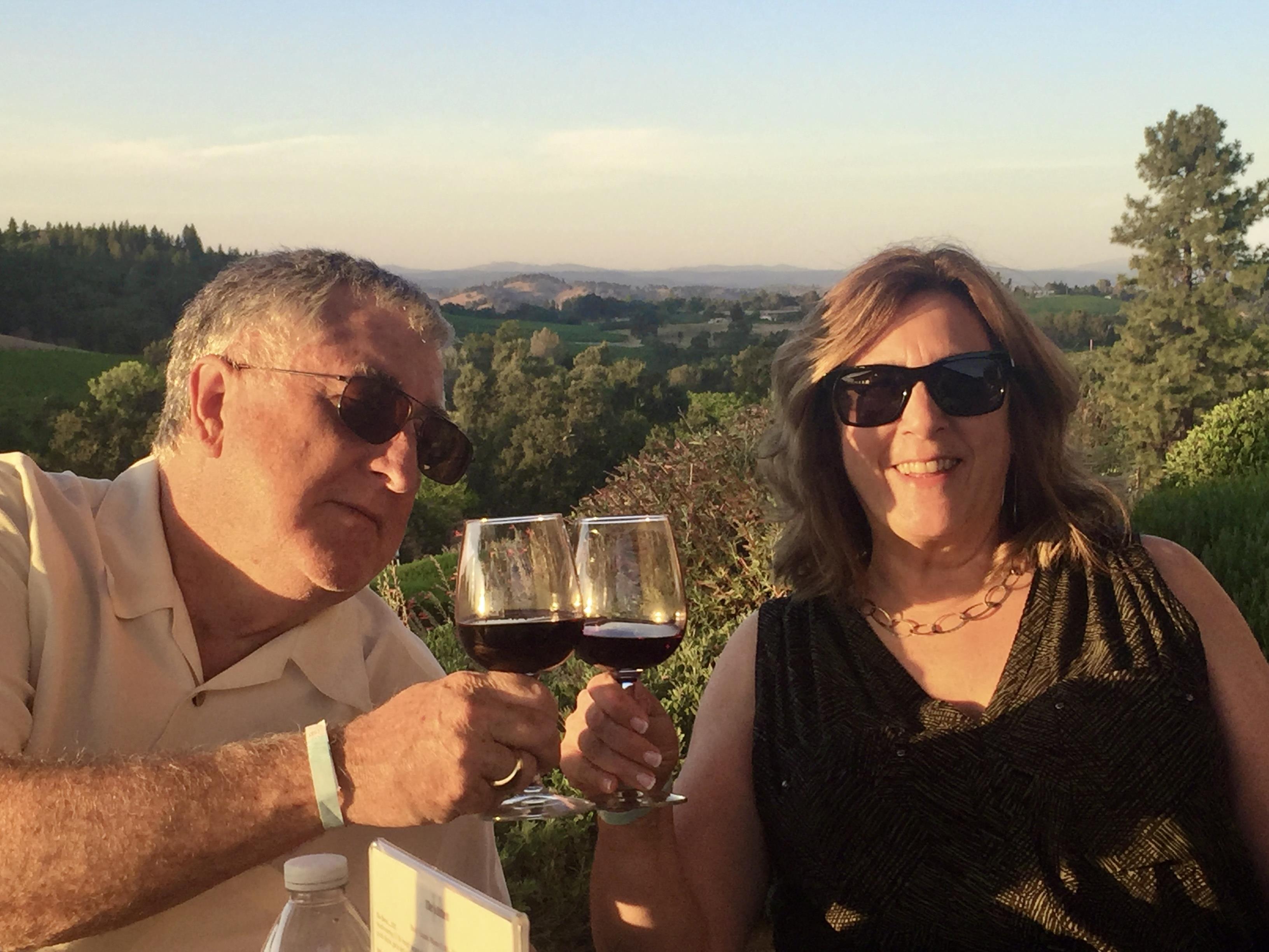 A man and woman holding wine glasses