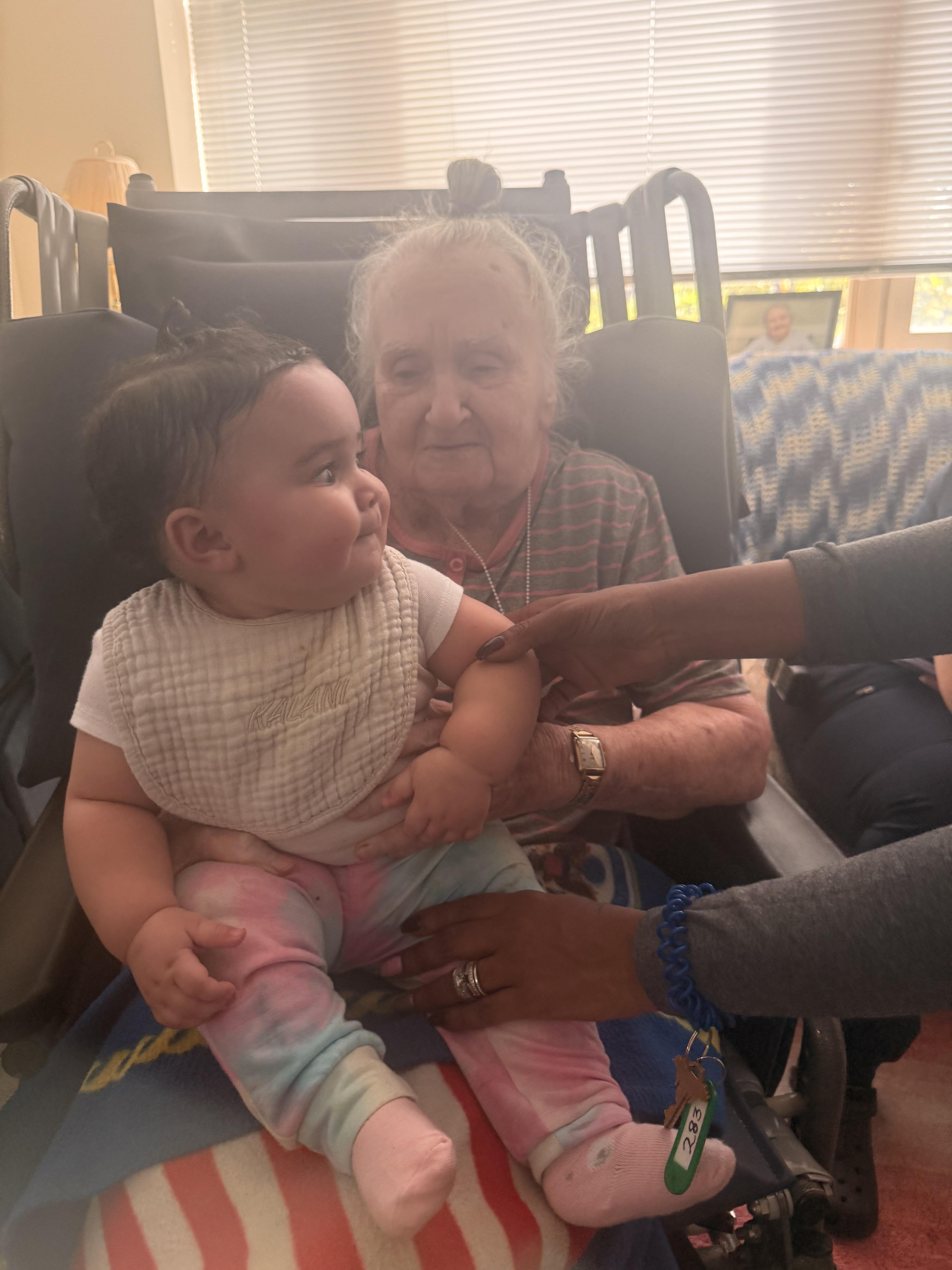 An old woman holding a baby