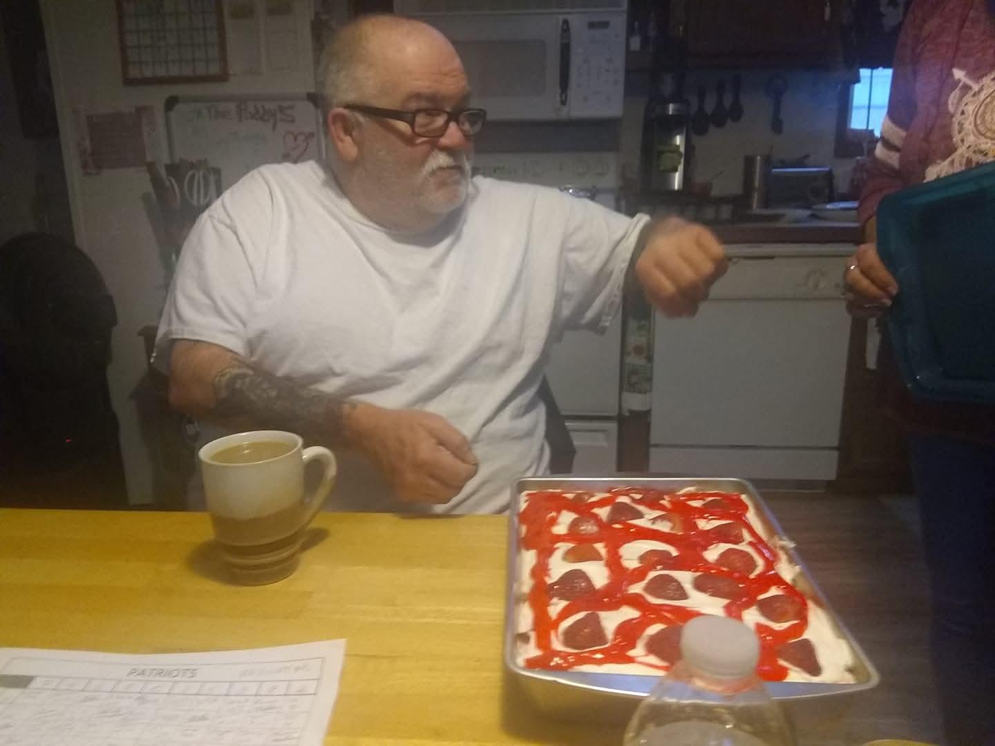 A man sitting at a table with a tray of food