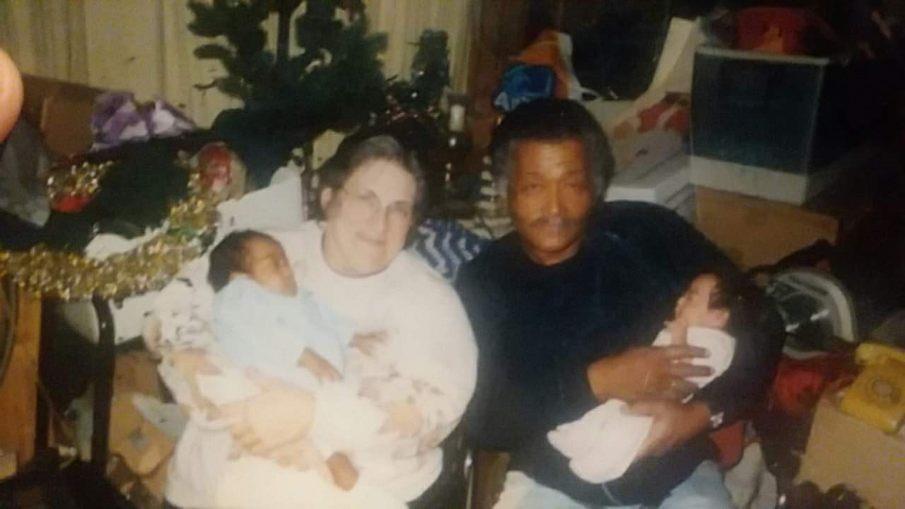 A man and woman holding a baby