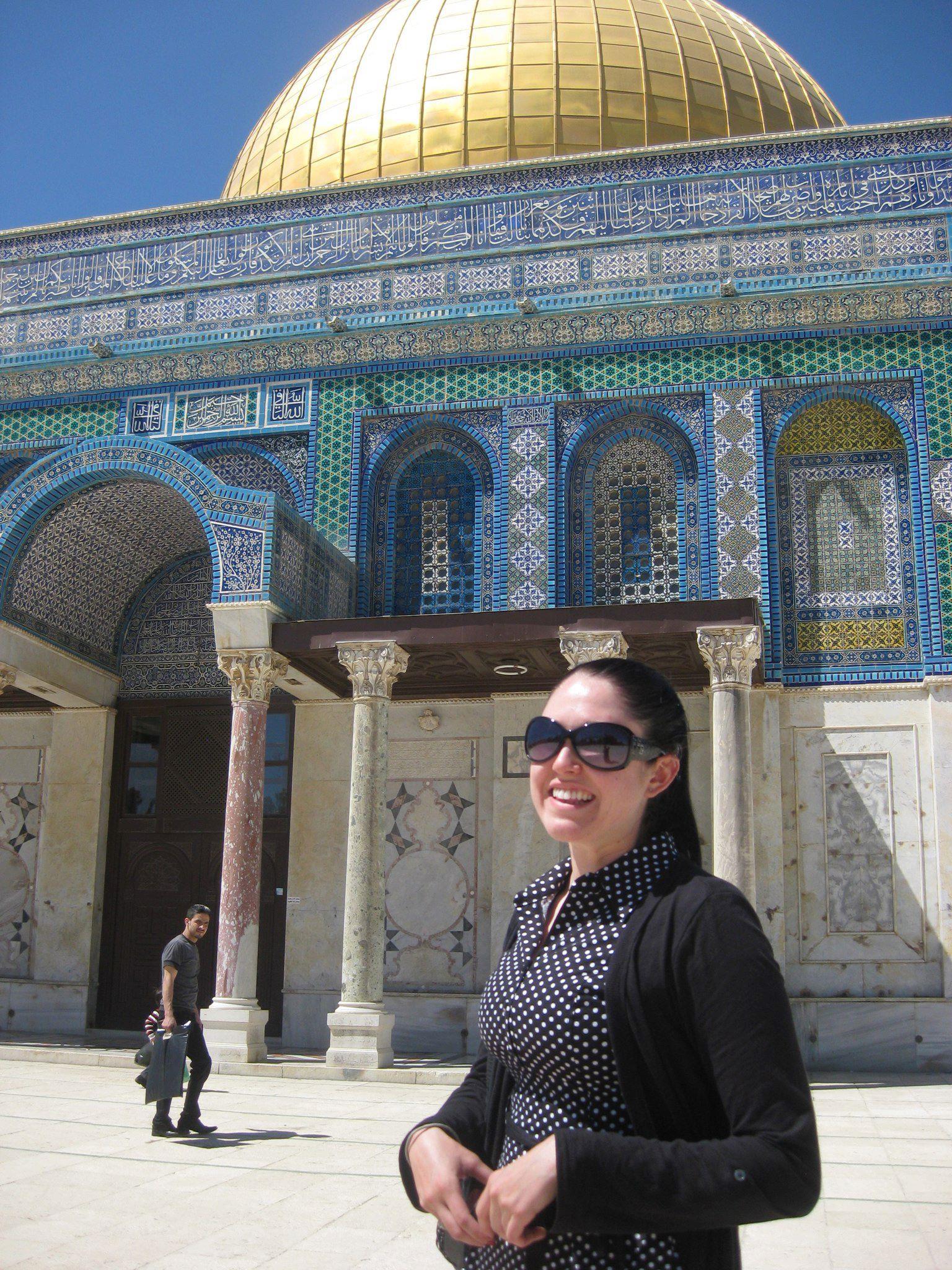 A woman standing in front of a building