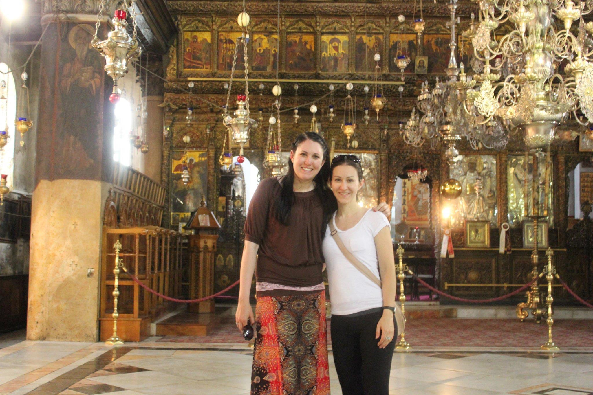 A couple of women standing in a church