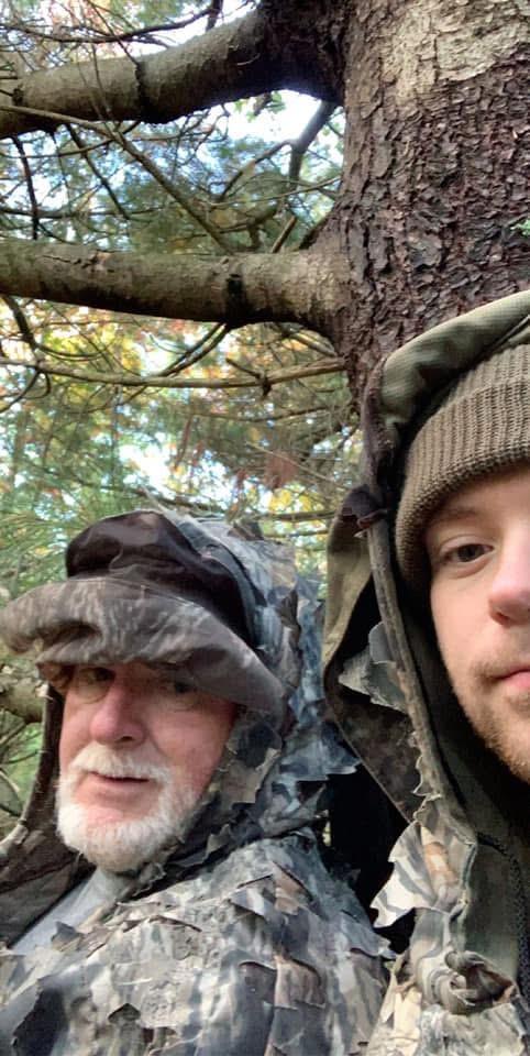 Two men in hats and hats under a tree