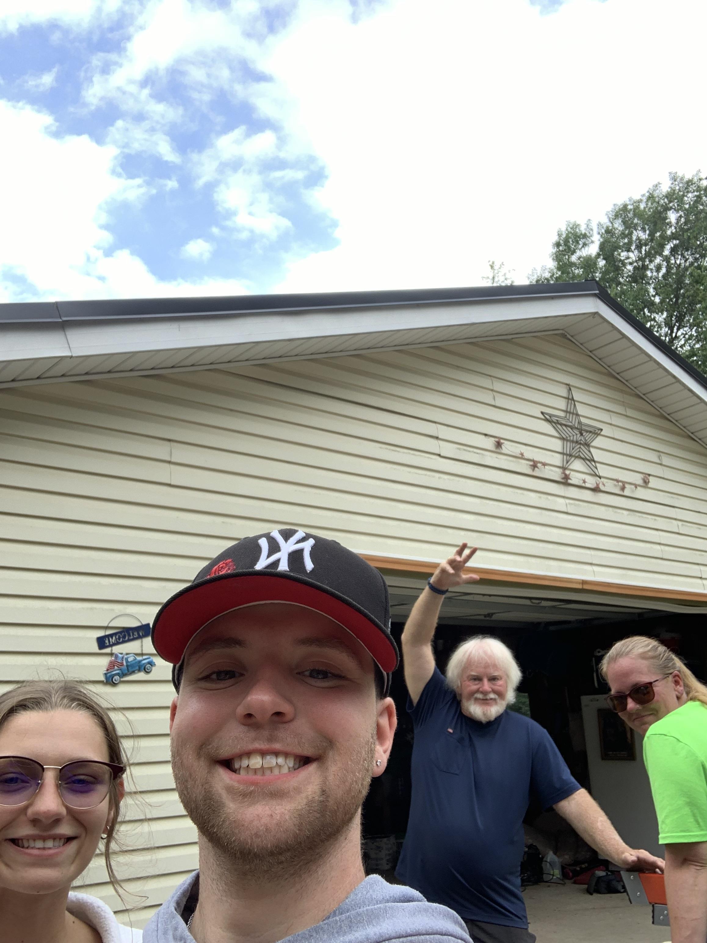 A group of people standing in front of a house