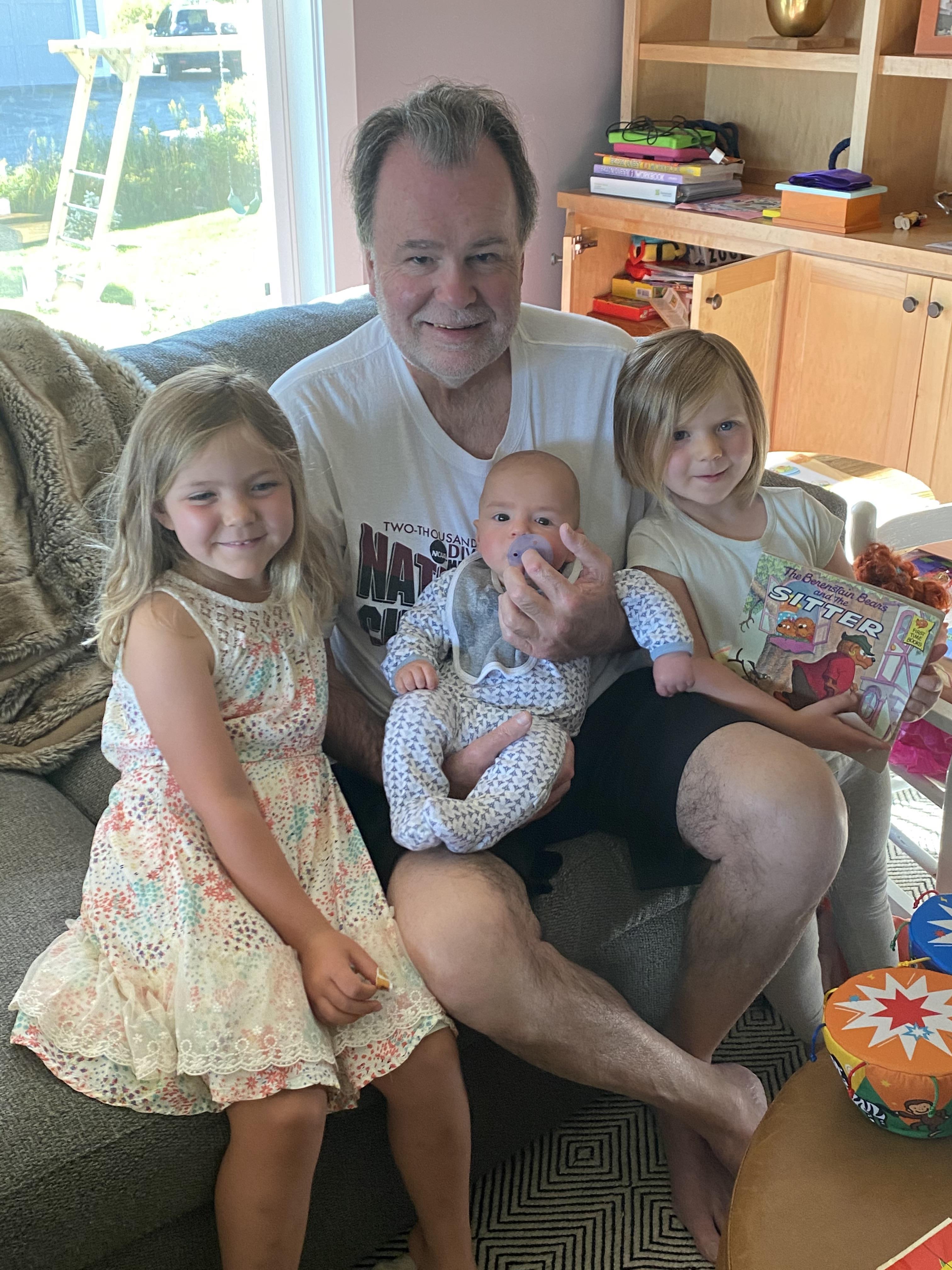 A man holding a baby and a baby with a baby and a baby