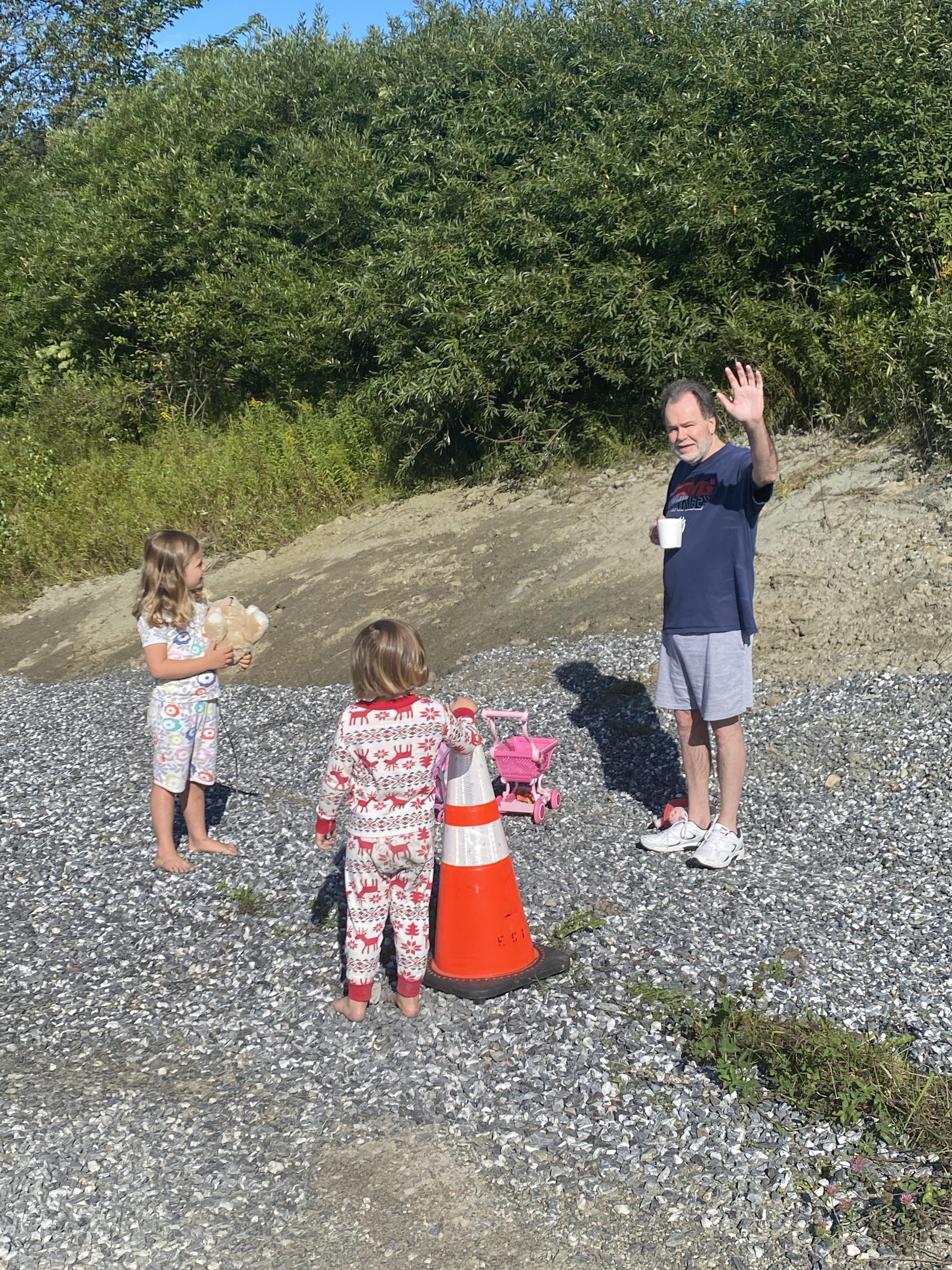 A man waving to a group of children