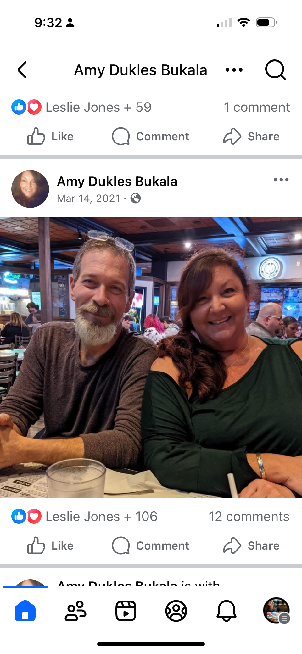 Two people are sitting at a restaurant, smiling and enjoying their time together with food.