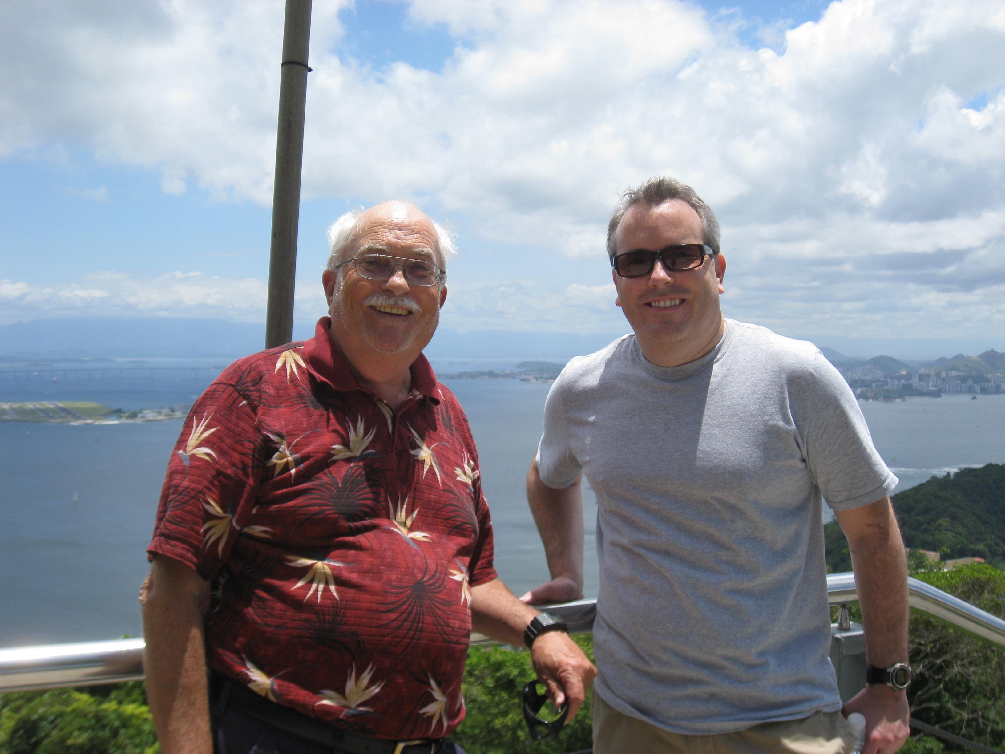 A couple of men standing on a balcony