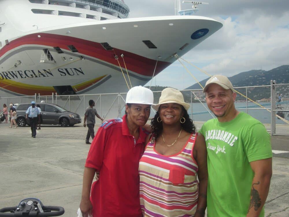 A group of people posing for a photo in front of a cruise ship