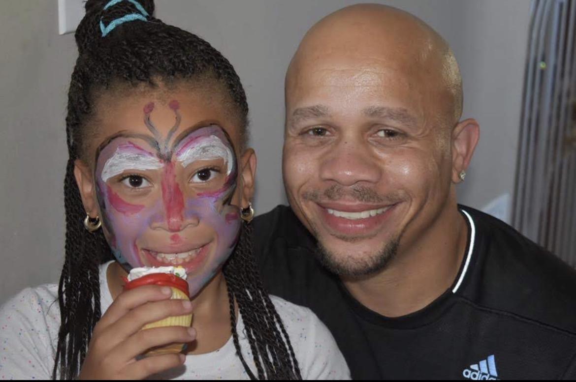 A man and a girl with face paint