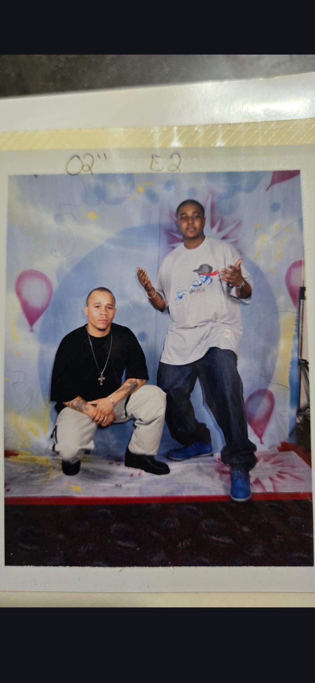 A man posing with another man