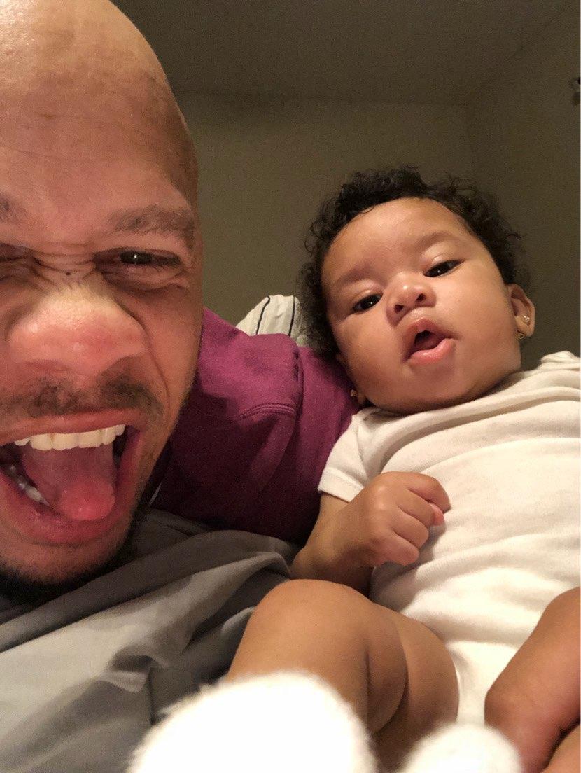 A man taking a selfie with a baby
