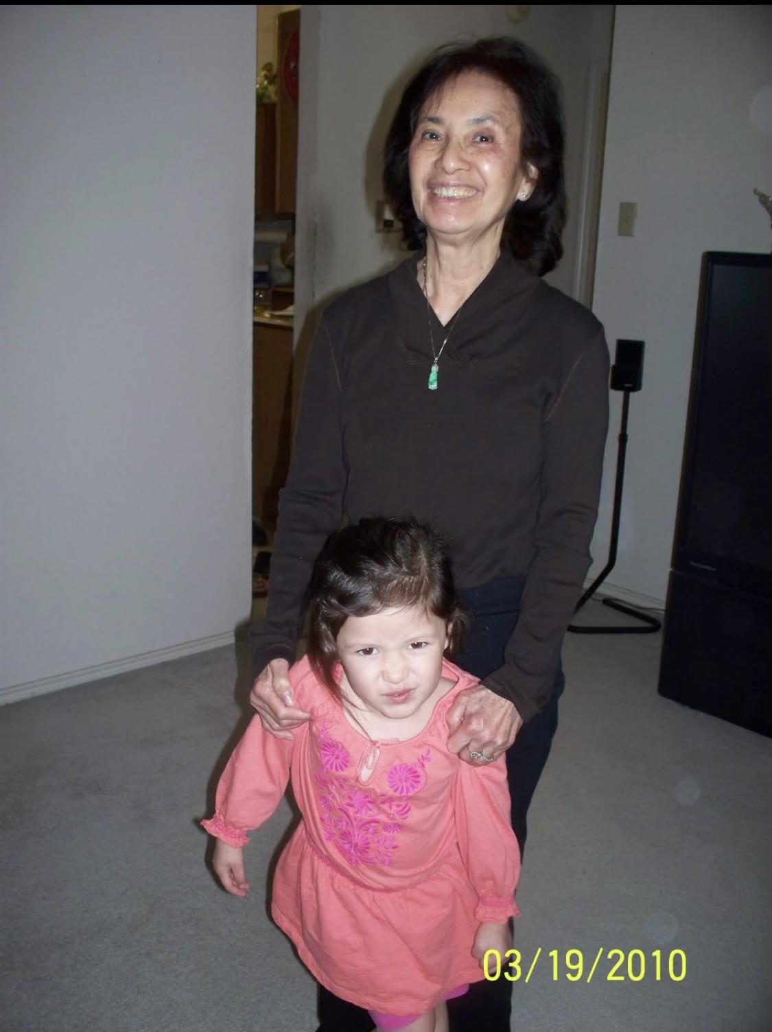 An older woman enjoys time with a young girl in a living room during a weekend visit.