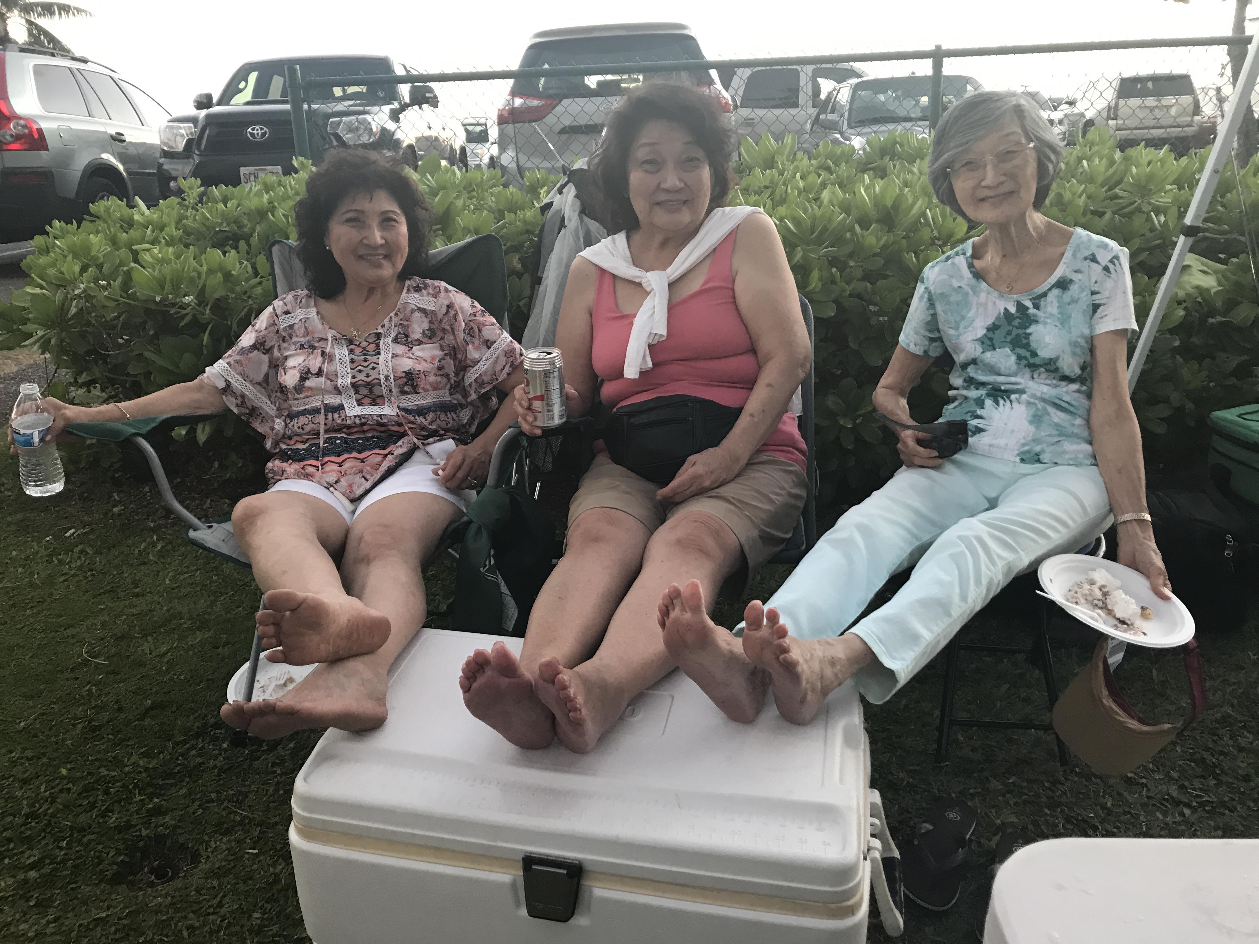 A group of women sitting on coolers