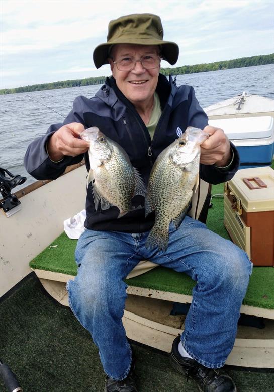 A man holding two fish