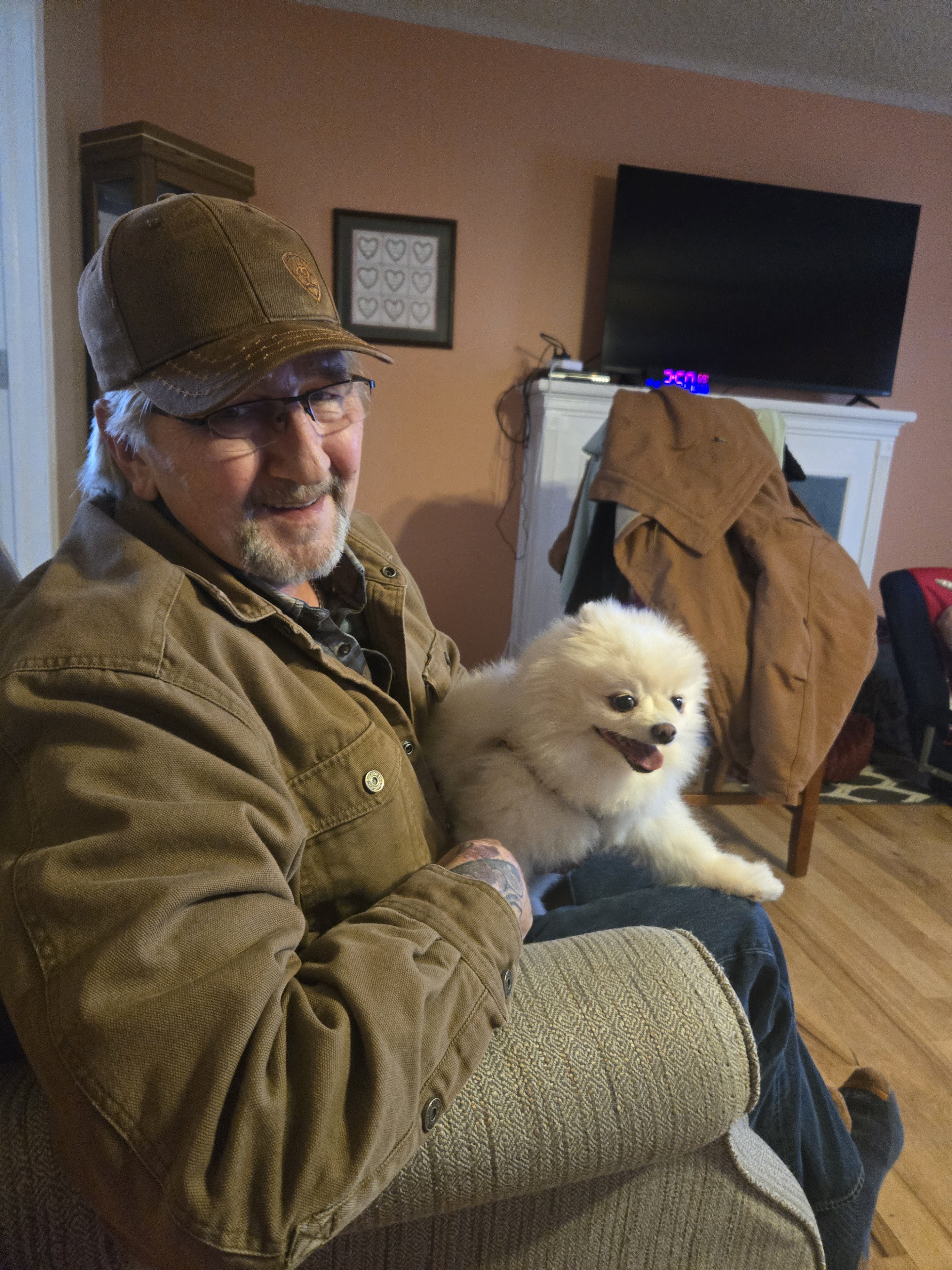 A man sitting on a chair with a dog