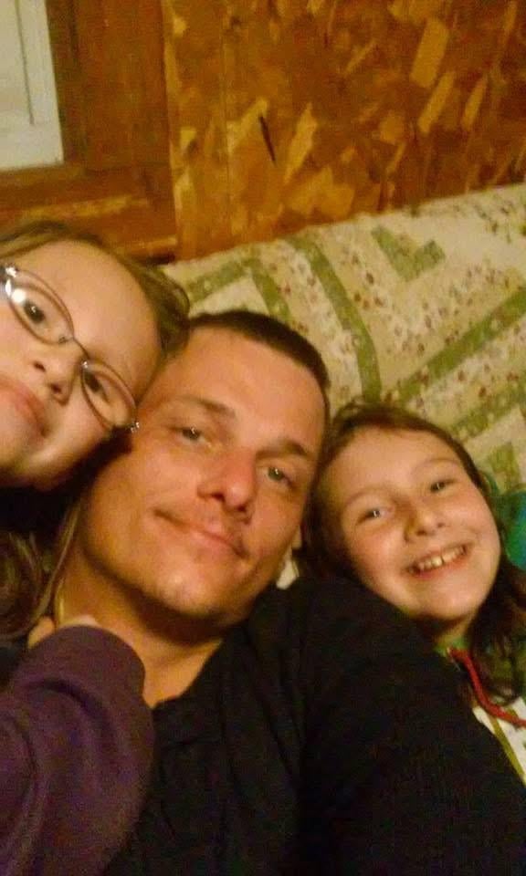 A man and two girls taking a selfie