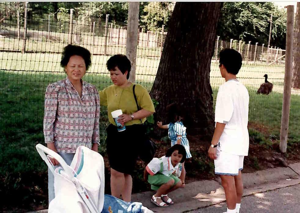 A group of people standing on the sidewalk