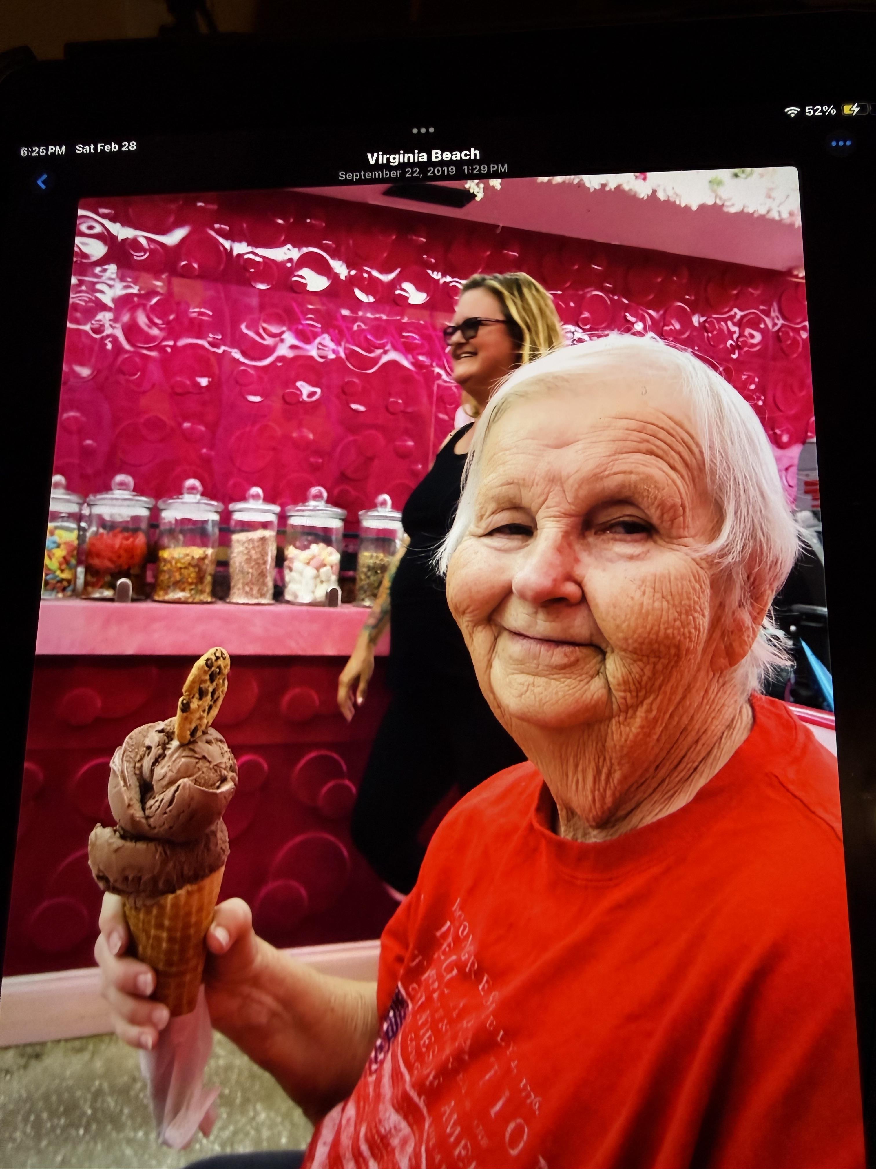 An older woman holding an ice cream cone