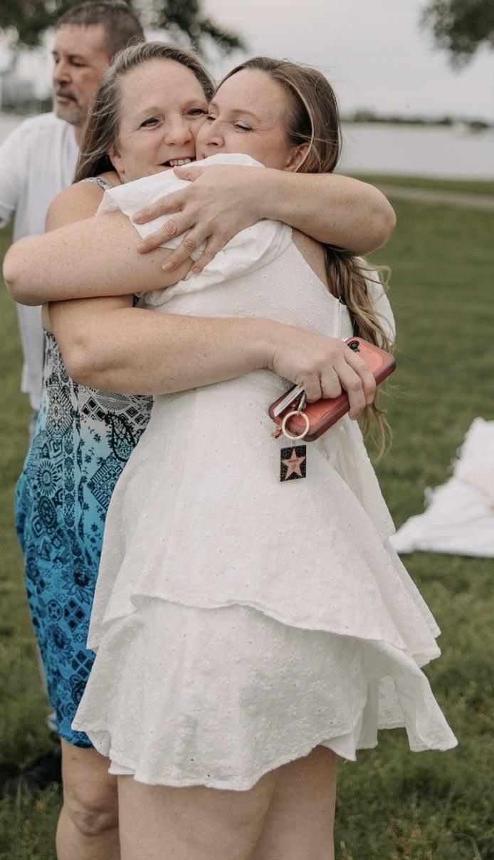 A woman hugging another woman