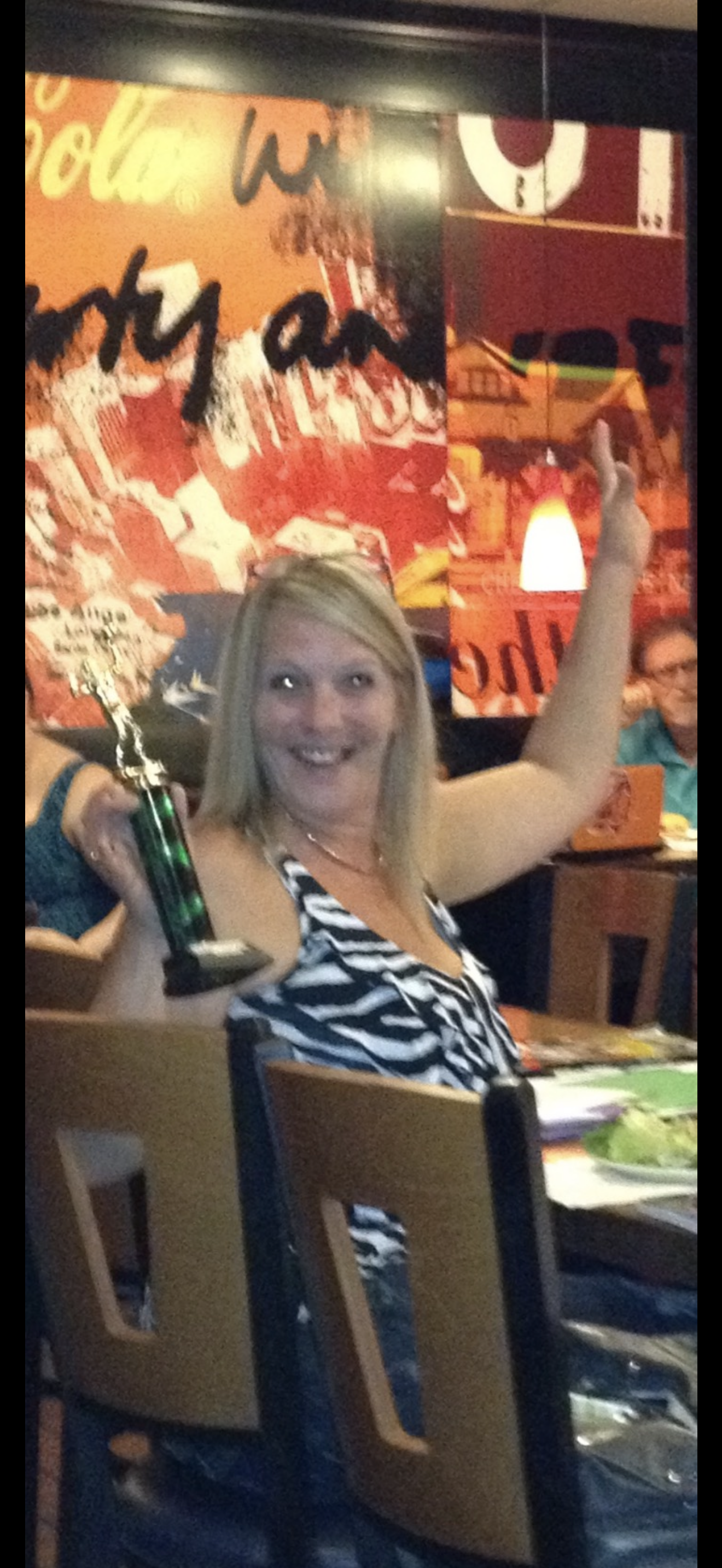 A woman holding a trophy