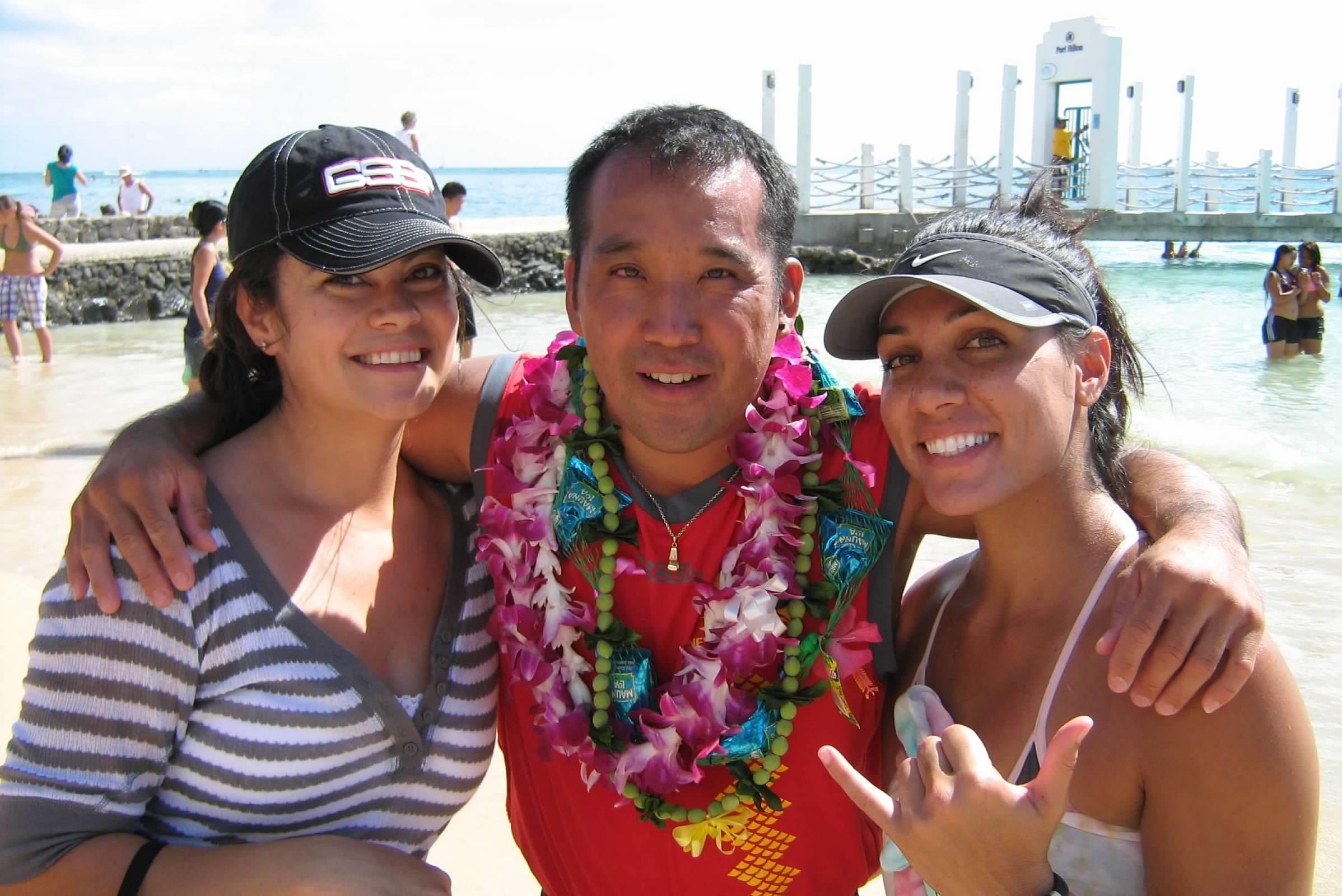 A man and two women posing for a picture